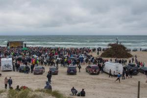 Most gather between the stage and the bonfire place